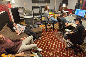 The band Soniqz during a break in the recording studio control room.
