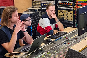 Listening back to drum recordings in the studio during a theatre production.