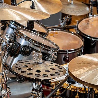 Sabian HHX cymbals by a drum kit.